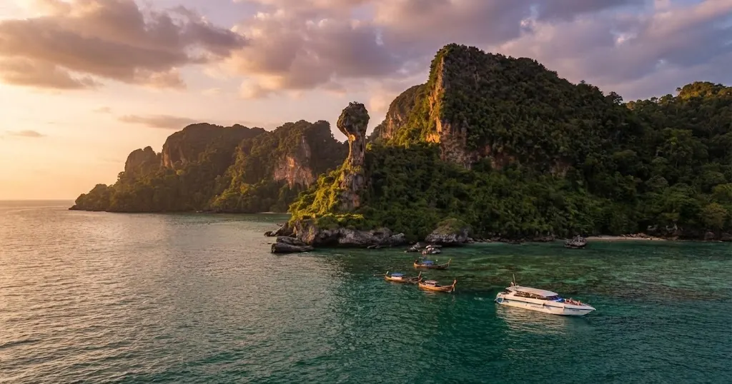 Aerial view of Chicken Island with a speedboat and longtails moored at the snorkeling area