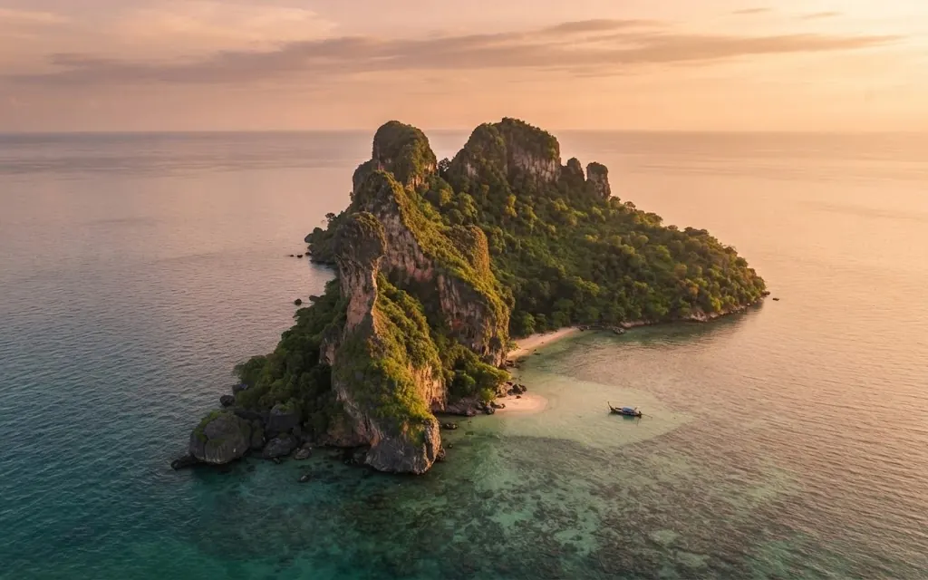 Aerial view of Chicken Island's jagged ridge in a calm, glassy sea