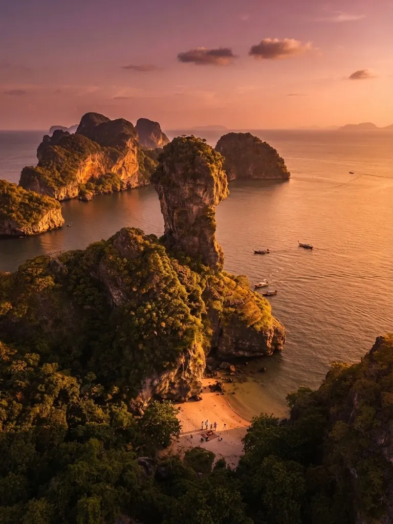 Aerial view of rock pinnacles and a small cove at sunset around Chicken Island