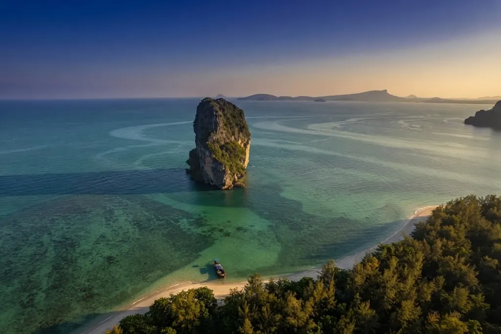 Aerial view of the Poda Island sea stack rising from turquoise shallows