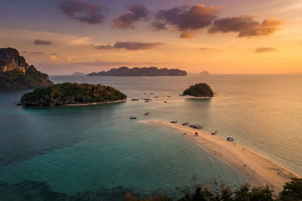 Aerial view of the Tup Island sandbar with boats at low tide and islands at sunset